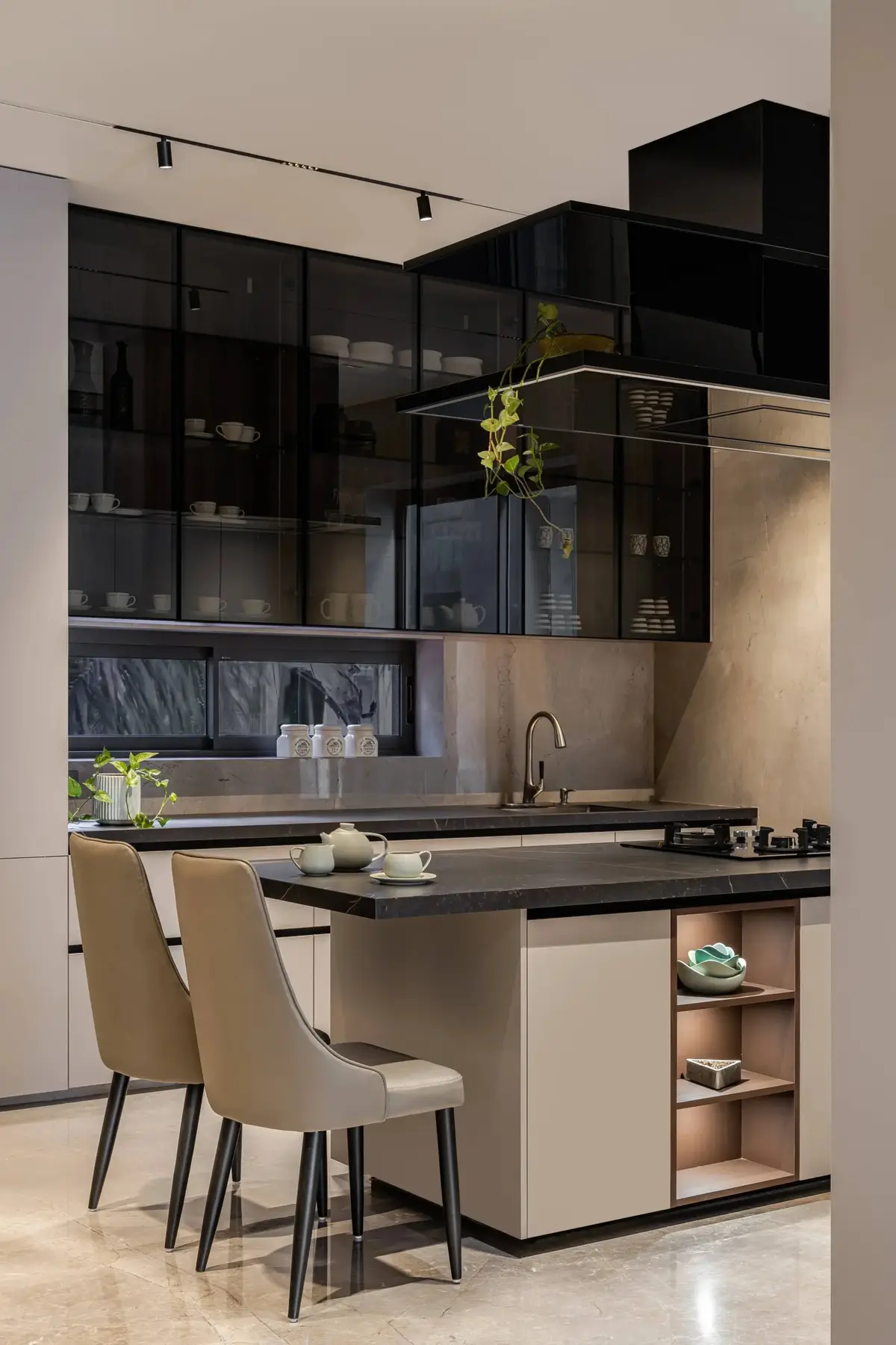 Kitchen island with bar stools and dark glass cabinetry